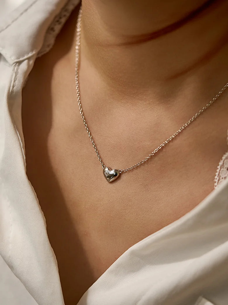 Close-up of a woman's neck showcasing Moissanite Heart Chain Necklace