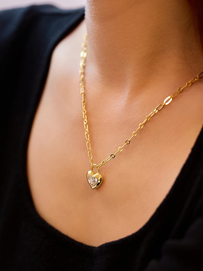 Close-up of a woman's neck showcasingMoissaniteHeartLockCharmNecklace