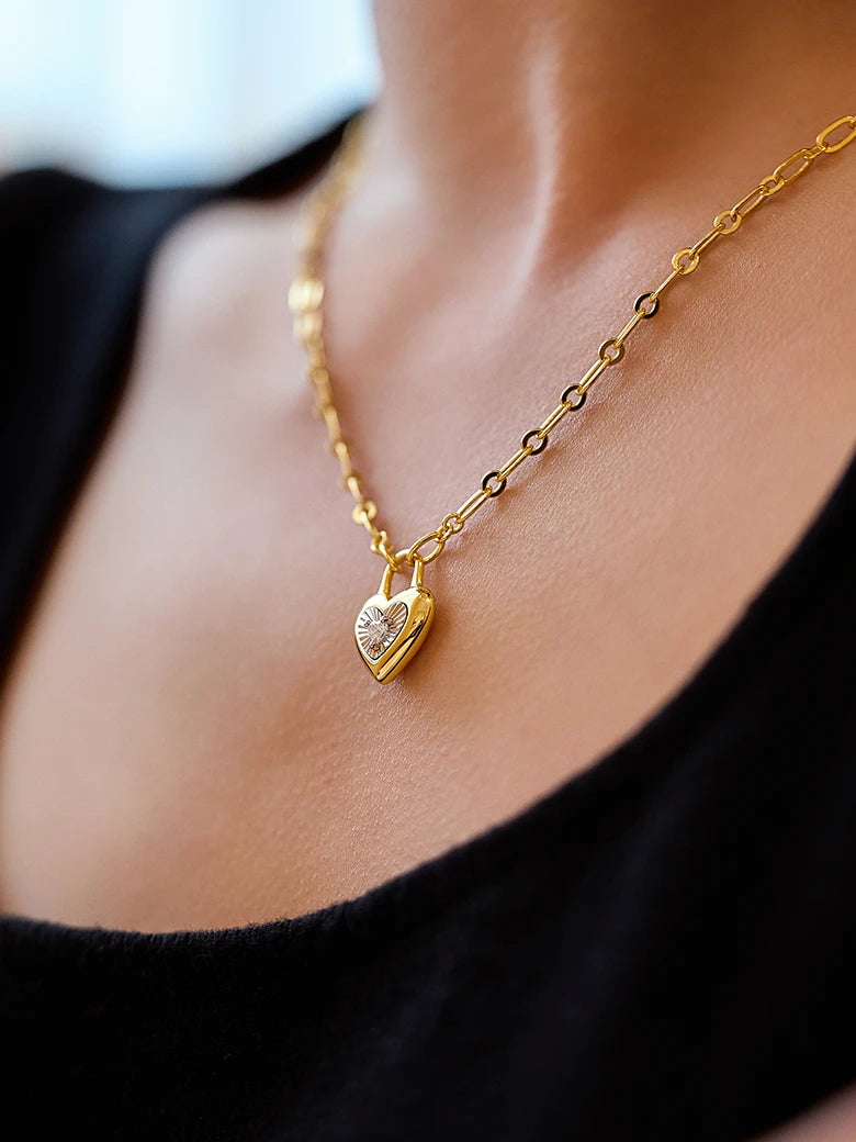 Close-up of a woman's neck showcasingMoissaniteHeartLockCharmNecklace