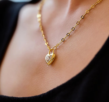 Close-up of a woman's neck showcasingMoissaniteHeartLockCharmNecklace