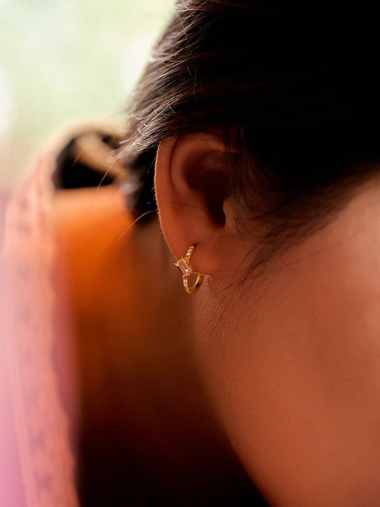 Close-up of a woman's ear showcasing MoissaniteHoopEarringswithMorganite