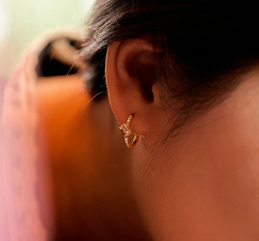 Close-up of a woman's ear showcasing MoissaniteHoopEarringswithMorganite