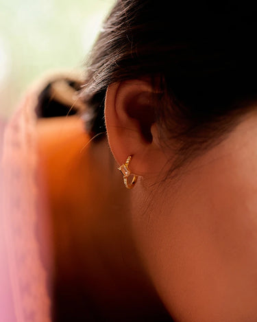 Close-up of a woman's ear showcasing MoissaniteHoopEarringswithMorganite