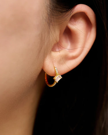 Close-up of a woman's ear showcasing MoissaniteHoopEarringswithMorganite