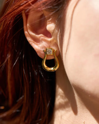 Close-up of a woman's ear showcasing Moissanite Lyre Earrings