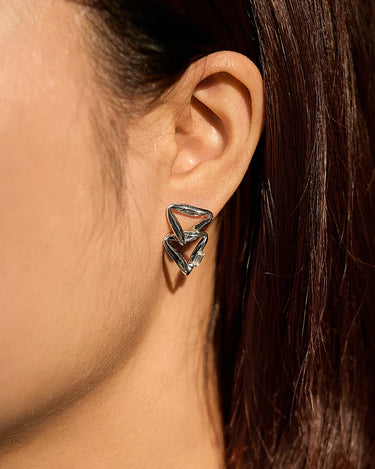 Close-up of a woman's neck showcasing MoissaniteOverlappedSilverTriangleEarrings