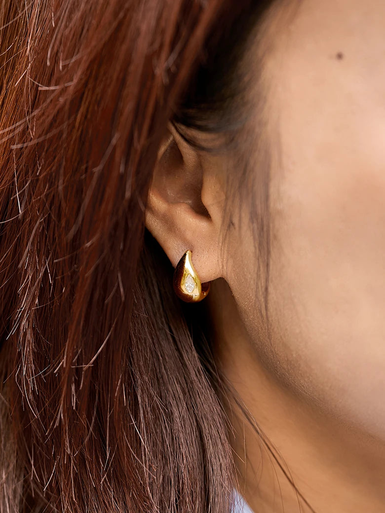 Close-up of a woman's neck showcasingMoissanite Teardrop Hoop Earrings