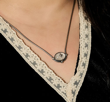 Close-up of a woman's neck showcasing MoonstoneSignatureCharmNecklace