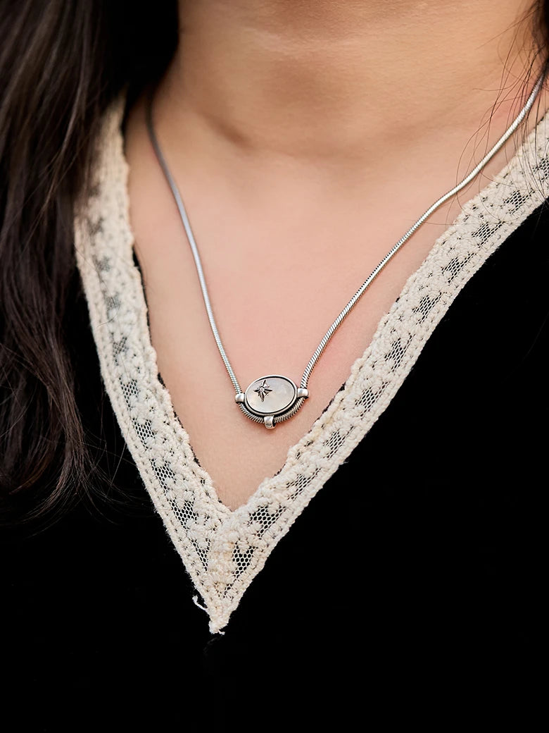 Close-up of a woman's neck showcasing MoonstoneSignatureCharmNecklace