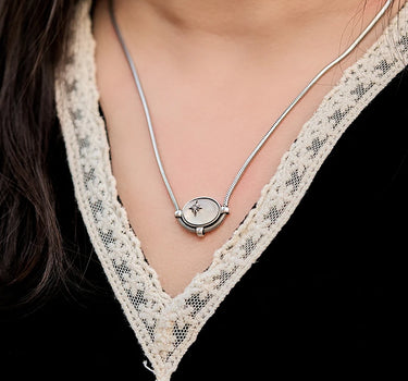 Close-up of a woman's neck showcasing MoonstoneSignatureCharmNecklace