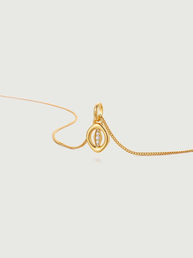 Oculus Diamond Charm Necklace featuring a minimalist gold design with a sparkling diamond accent on a delicate chain.