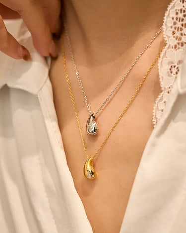 Close-up of a woman's neck showcasing Pear Cut Moissanite Drop Necklace