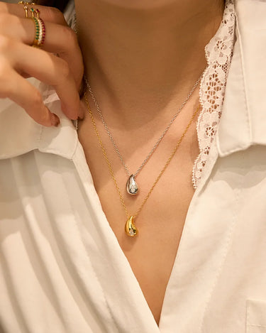 Close-up of a woman's neck showcasing Pear Cut Moissanite Drop Silver Necklace