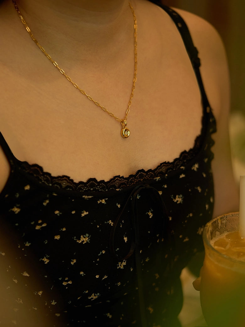 A close-up of the Pear Dome Pendant Necklace worn on a person, showcasing its elegant moissanite stone and modern design.