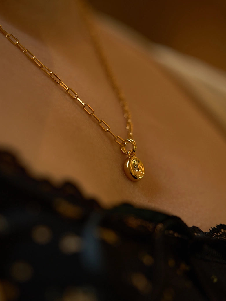 Pear Dome Pendant Necklace showcased on a model, featuring a moissanite stone and paperclip chain.