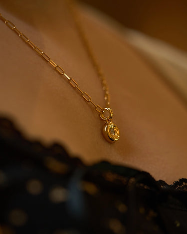 Pear Dome Pendant Necklace showcased on a model, featuring a moissanite stone and paperclip chain.