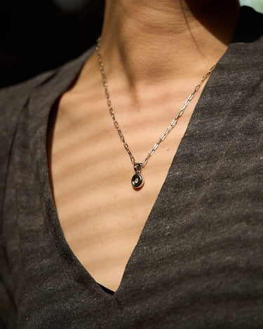 Pear Dome Silver Pendant Necklace featuring a domed pendant on a stylish paperclip chain worn by a model.