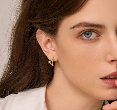 Close-up of a woman's ear showcasing PearlArcEarrings