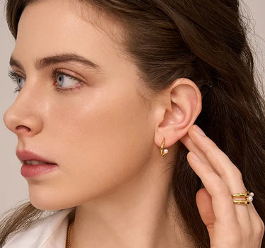 Close-up of a woman's ear showcasing PearlArcEarrings