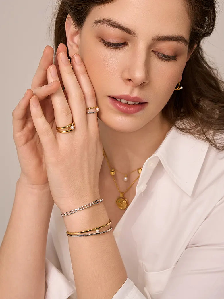 Close-up of a woman's neck showcasing PearlCuffTwoToneBangle