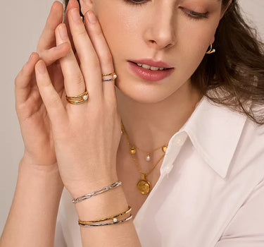 Close-up of a woman's neck showcasing PearlCuffTwoToneBangle