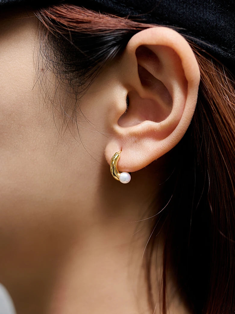 Close-up of a woman's ear showcasing Pearl Dainty Hoop Earrings