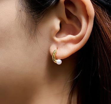 Close-up of a woman's ear showcasing Pearl Dainty Hoop Earrings