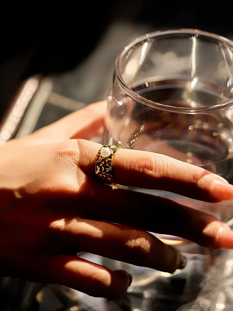 Close-up of a woman's finger showcasing Pearl Wide Band Ring