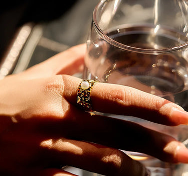 Close-up of a woman's finger showcasing Pearl Wide Band Ring