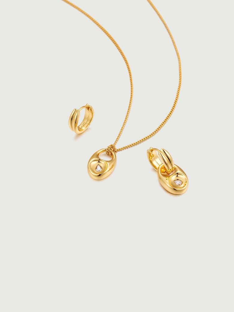 Pebble Solitaire Drops Earrings featuring gold tone necklace and earrings with moissanite accents.