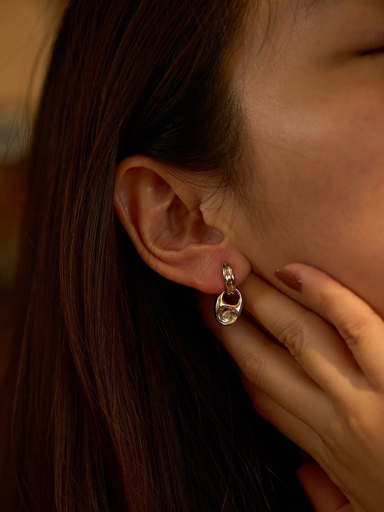 Pebble Solitaire Drops Silver Earrings worn by a woman, showcasing the elegant design and versatility.