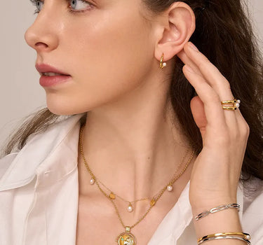 Close-up of a woman's neck showcasing PrayGirlEmeraldCoinNecklace