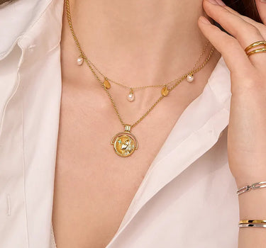 Close-up of a woman's neck showcasing PrayGirlEmeraldCoinNecklace
