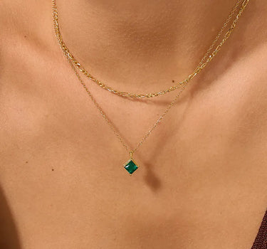 Close-up of a woman's neck showcasing Princess Cut Emerald Diamond Necklace