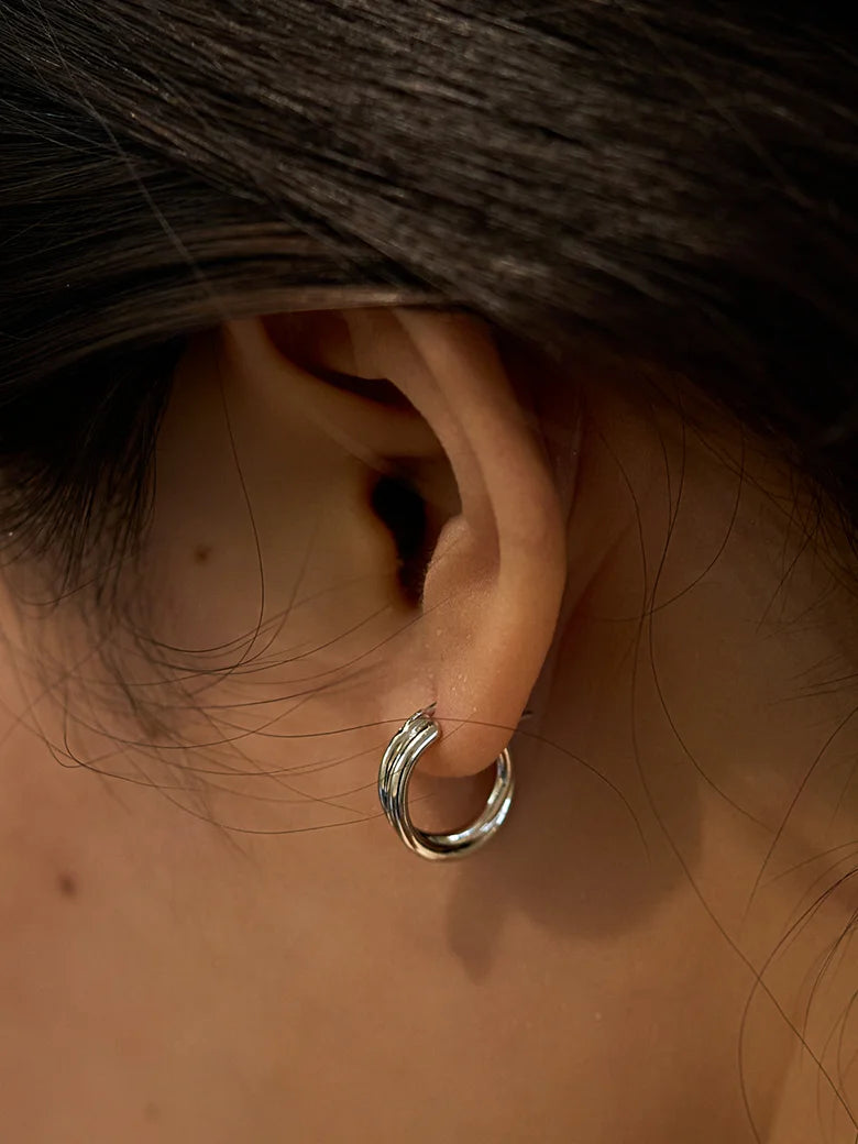 Close-up of a woman's ear showcasing SilverDoubleHoopEarrings