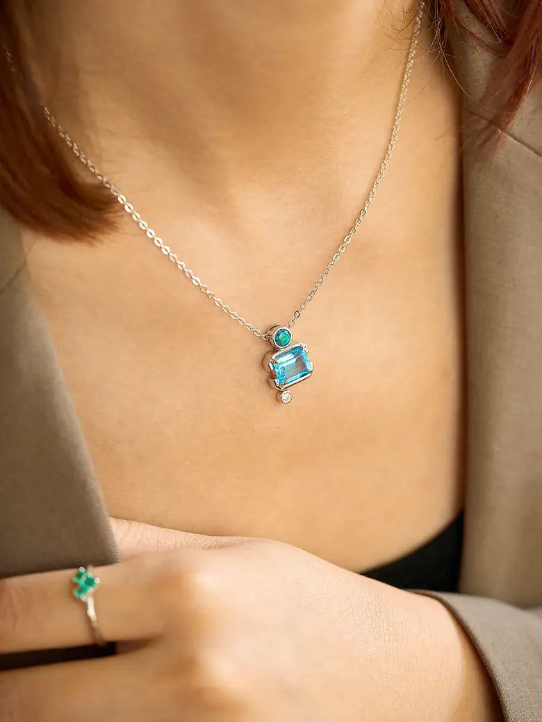 Close-up of a woman's neck showcasing Slideable Versailles Topaz Necklace