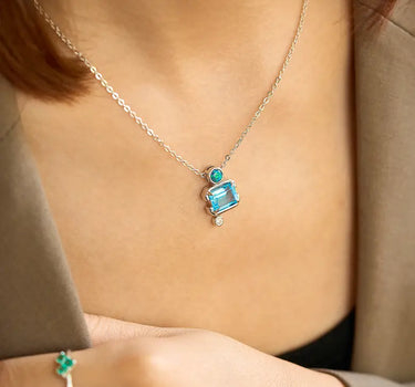 Close-up of a woman's neck showcasing Slideable Versailles Topaz Necklace