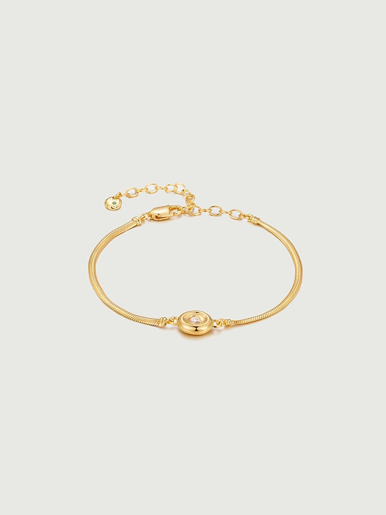 Solitaire Snake Chain Bracelet featuring a sleek design with a single solitaire diamond on a polished gold chain.