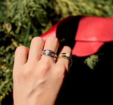 Close-up of a woman's finger showcasing Double Hoop Pearl Stacking Silver Ring