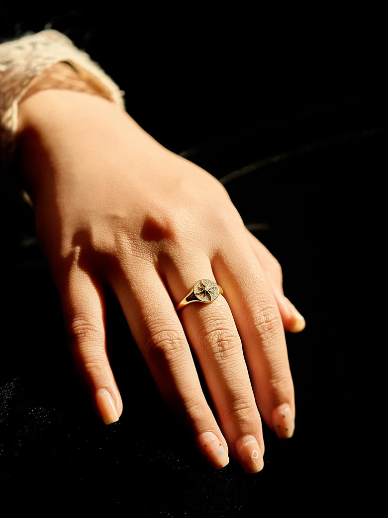 Close-up of a woman's finger showcasing SunSignetRing