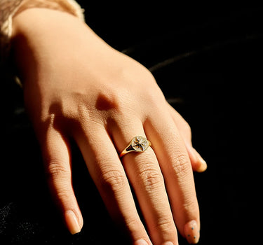 Close-up of a woman's finger showcasing Diamond Sun Signet Ring