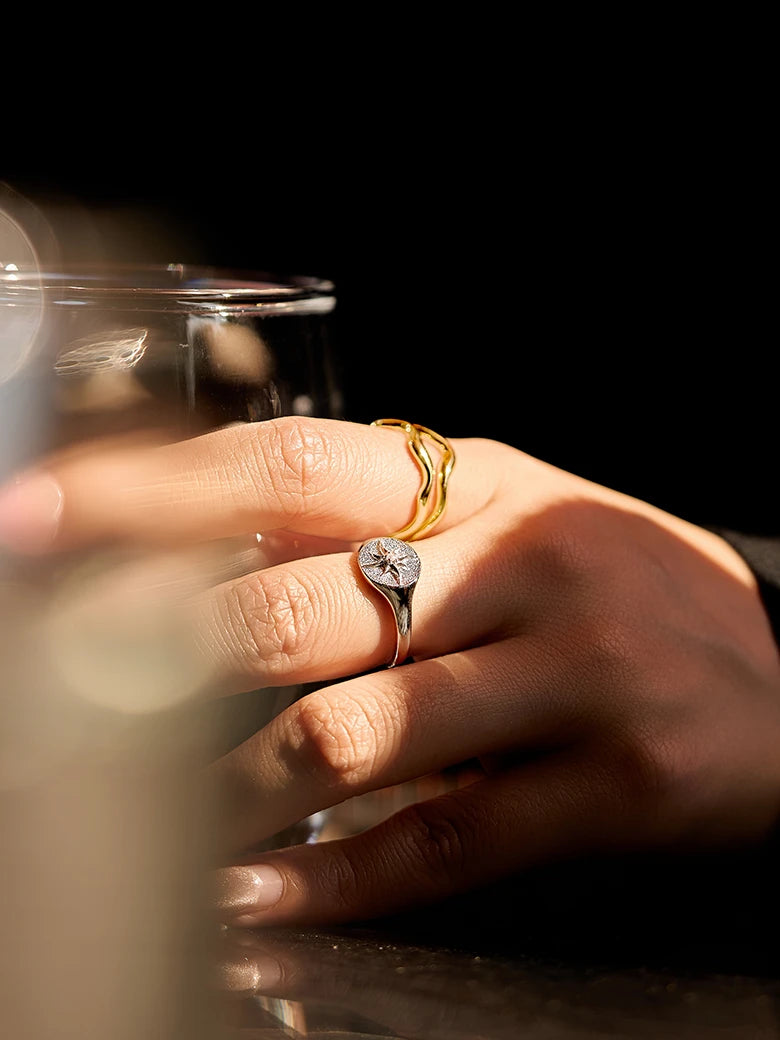 Close-up of a woman's finger showcasing SunSignetSilverRing