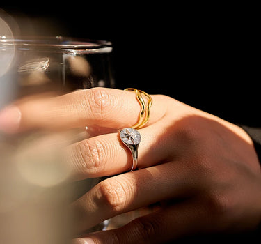 Close-up of a woman's finger showcasing Diamond Sun Signet Silver Ring