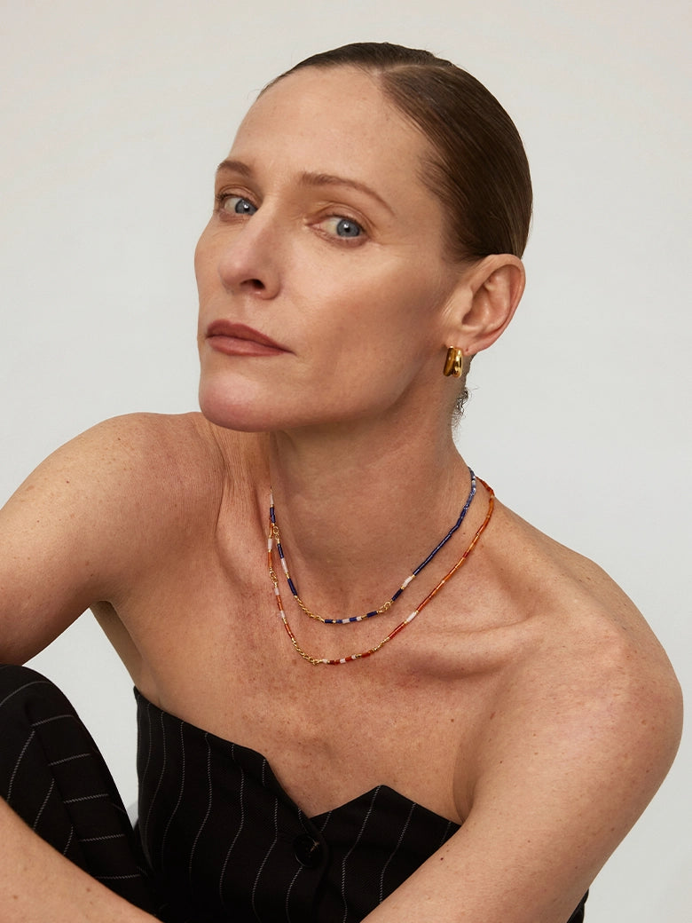 Close-up of a woman's neck showcasing SunsetOnyxMosaicNecklace