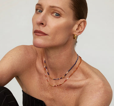 Close-up of a woman's neck showcasing SunsetOnyxMosaicNecklace