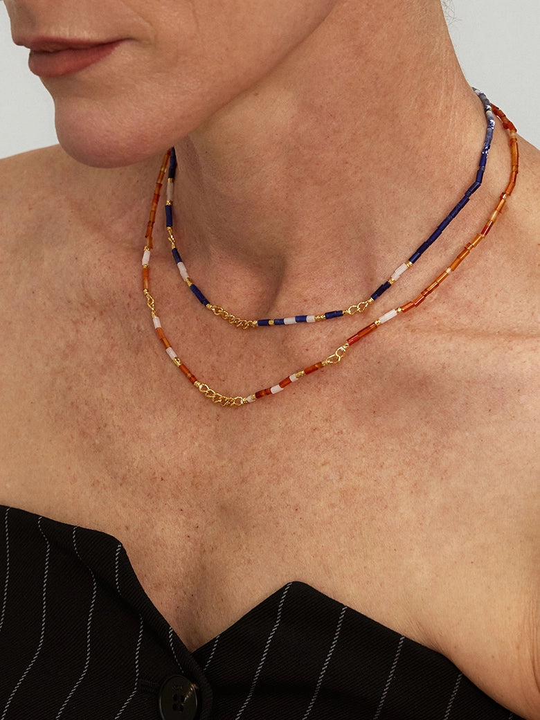 Close-up of a woman's neck showcasing SunsetOnyxMosaicNecklace