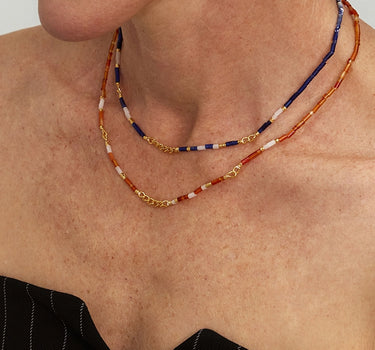 Close-up of a woman's neck showcasing SunsetOnyxMosaicNecklace