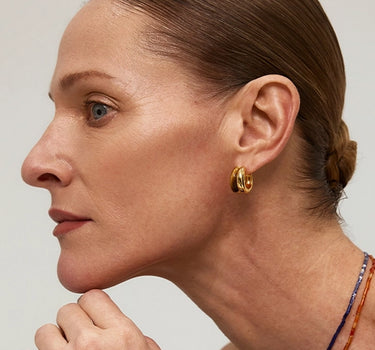 Close-up of a woman's ear showcasing Tiger_sEyeDuoHoopEarrings 