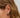 Close-up of a woman's ear showcasing Tiger_sEyeDuoHoopSilverEarrings