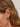 Close-up of a woman's ear showcasing Tiger_sEyeDuoHoopSilverEarrings